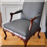 F11. One of a pair of carved open arm chairs. 41”h x 27”w x 30”d 